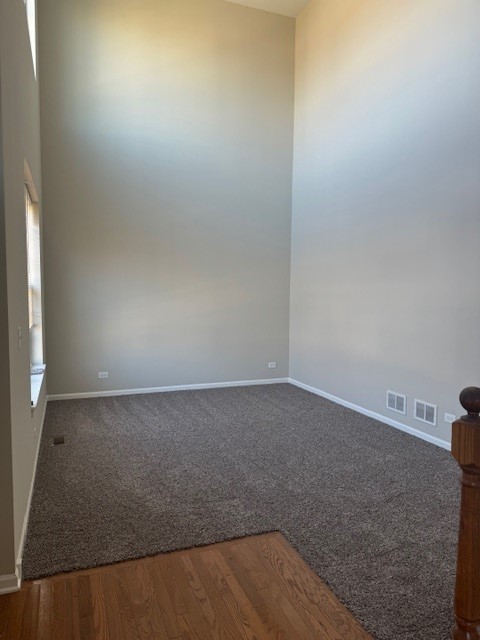 unfurnished room with wood-type flooring