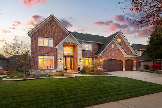 traditional home with brick siding, concrete driveway, and a yard