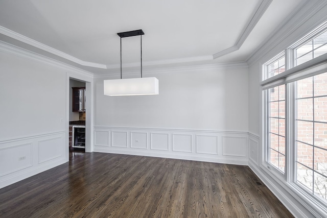 unfurnished dining area featuring crown molding, dark wood-style floors, and wainscoting