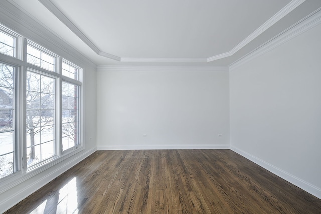 empty room with dark wood-type flooring, baseboards, and ornamental molding