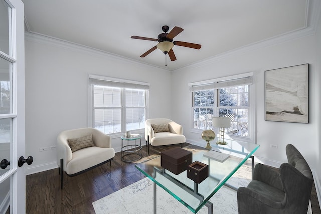 living room with crown molding, wood finished floors, baseboards, and ceiling fan