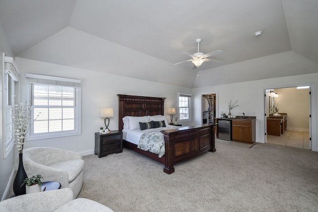 bedroom with lofted ceiling, a spacious closet, light colored carpet, and baseboards