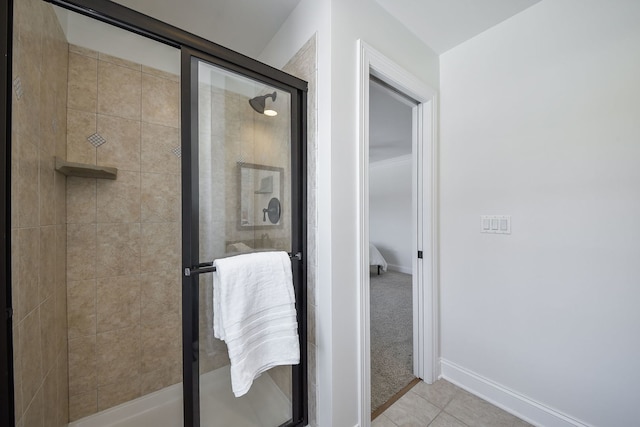 full bathroom with tile patterned floors, baseboards, and a shower stall