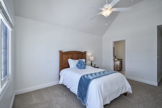 carpeted bedroom featuring ceiling fan, baseboards, high vaulted ceiling, and ensuite bath