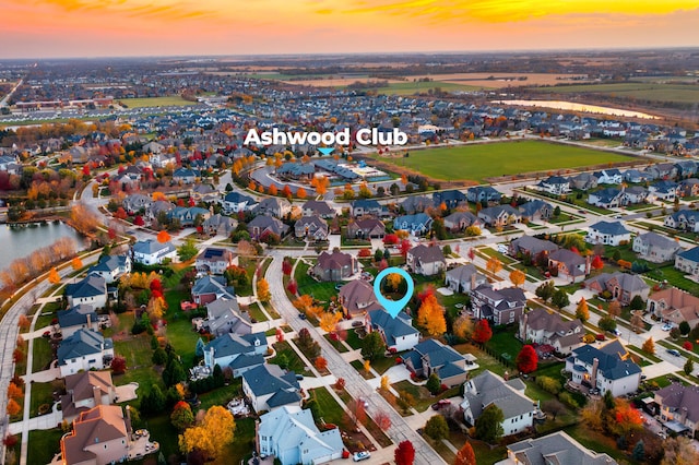 drone / aerial view featuring a residential view and a water view