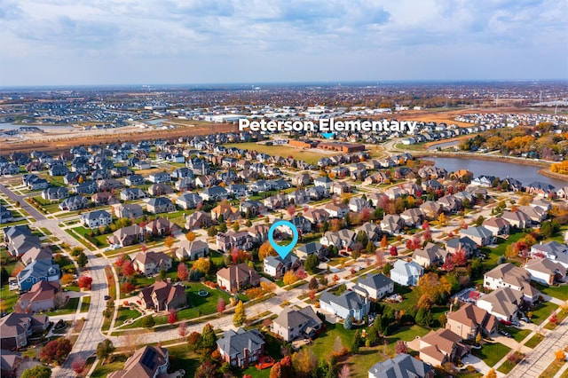 drone / aerial view featuring a residential view and a water view