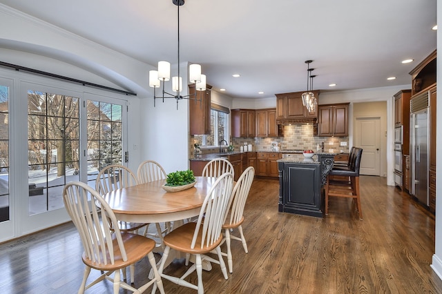 dining room featuring dark wood finished floors, recessed lighting, visible vents, and ornamental molding