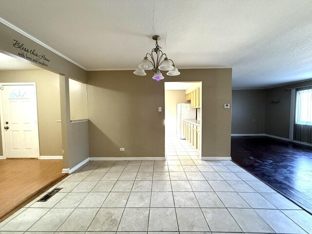 450 Shabbona Dr, Park Forest, IL 60466 - unfurnished room featuring a chandelier, crown molding, a textured ceiling, and light tile patterned floors