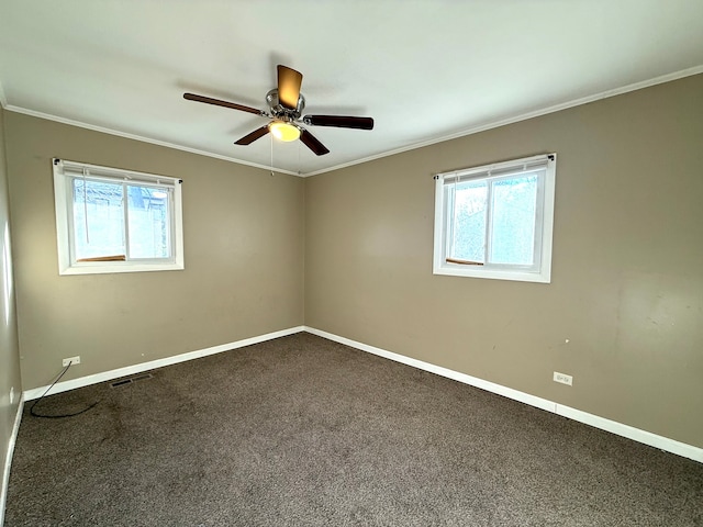 carpeted spare room featuring ceiling fan and ornamental molding