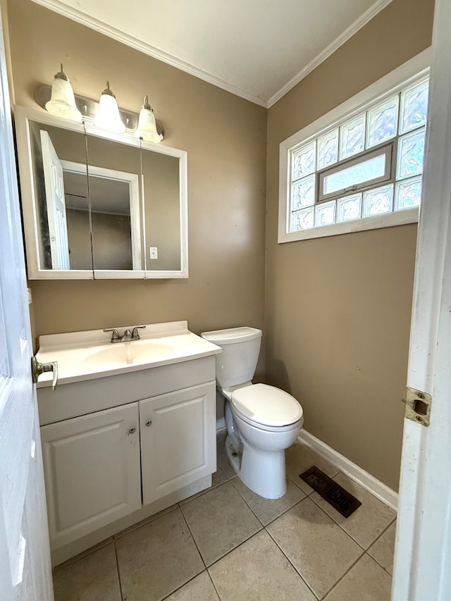 bathroom featuring tile patterned flooring, vanity, toilet, and ornamental molding