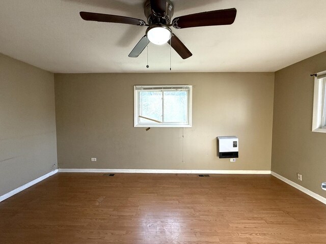 450 Shabbona Dr, Park Forest, IL 60466 - empty room featuring heating unit, wood finished floors, and ceiling fan