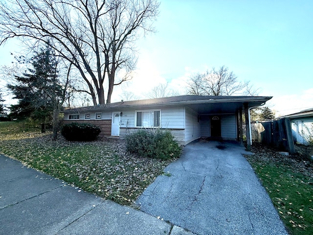 ranch-style home with a carport and a front yard