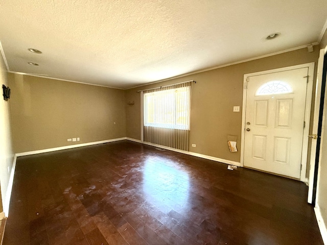 foyer entrance featuring a textured ceiling, crown molding, and dark hardwood / wood-style floors