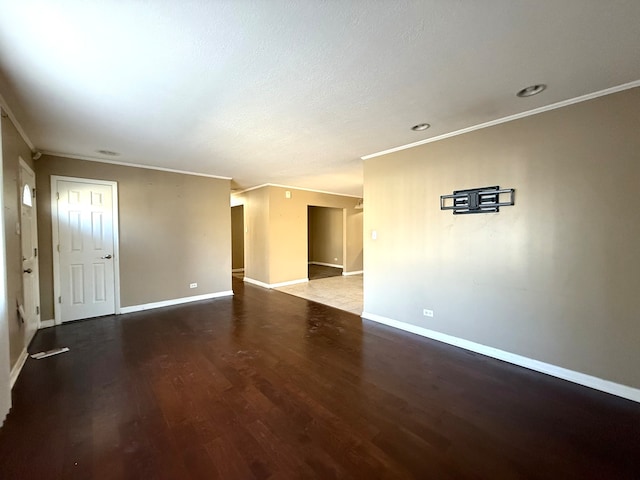 spare room with hardwood / wood-style floors, crown molding, and a textured ceiling