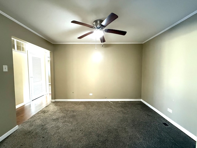 carpeted spare room featuring ceiling fan and ornamental molding