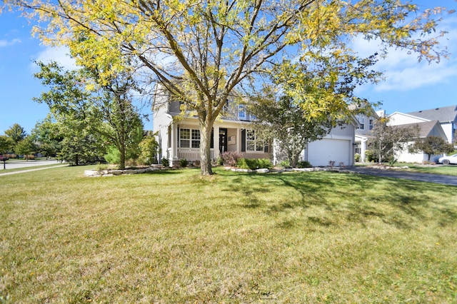 view of front of property featuring a garage and a front lawn