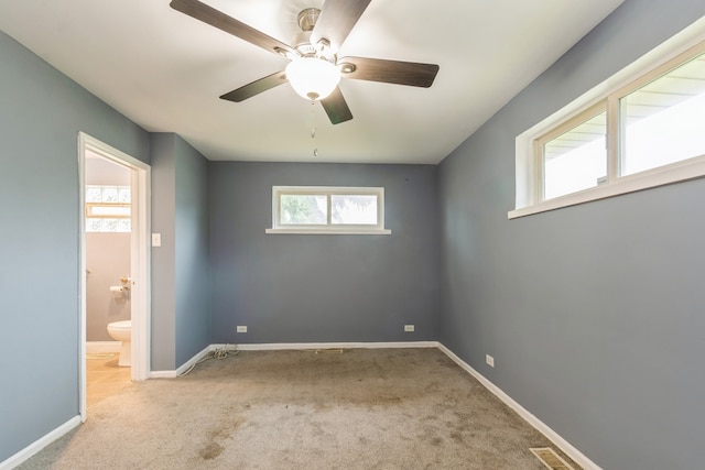 carpeted spare room with ceiling fan and a healthy amount of sunlight