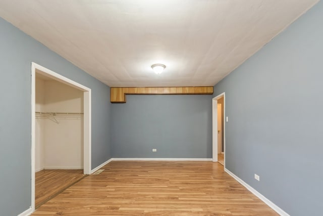 unfurnished bedroom with a closet and light hardwood / wood-style flooring