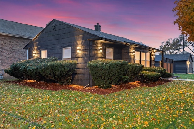 property exterior at dusk with a yard