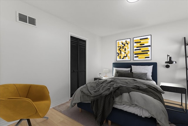 bedroom featuring a closet and light hardwood / wood-style floors