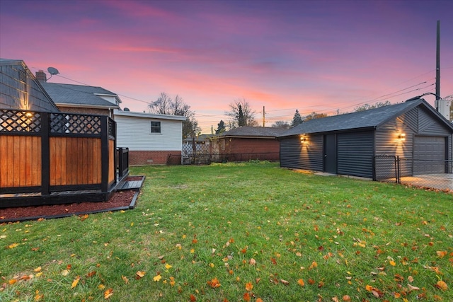 yard at dusk featuring an outbuilding