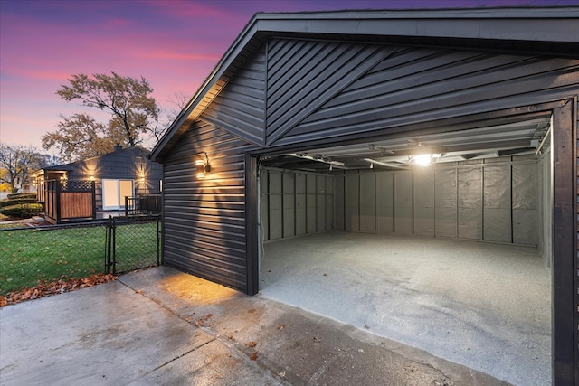 view of garage at dusk