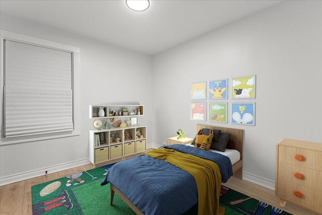 bedroom with hardwood / wood-style flooring