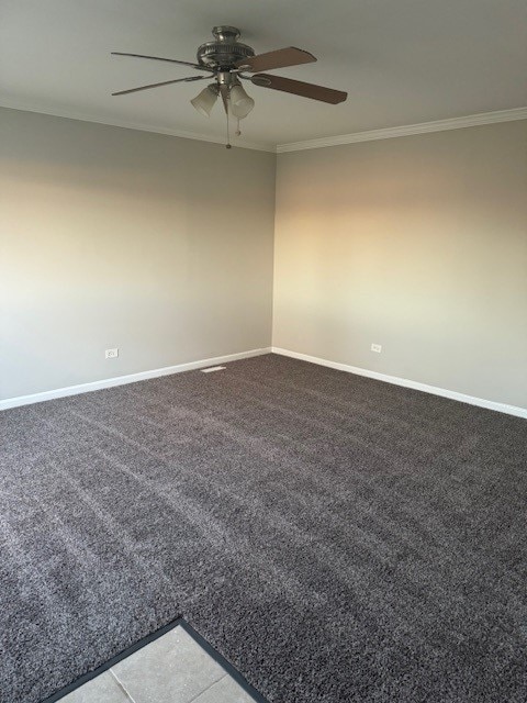 carpeted empty room featuring ceiling fan and crown molding