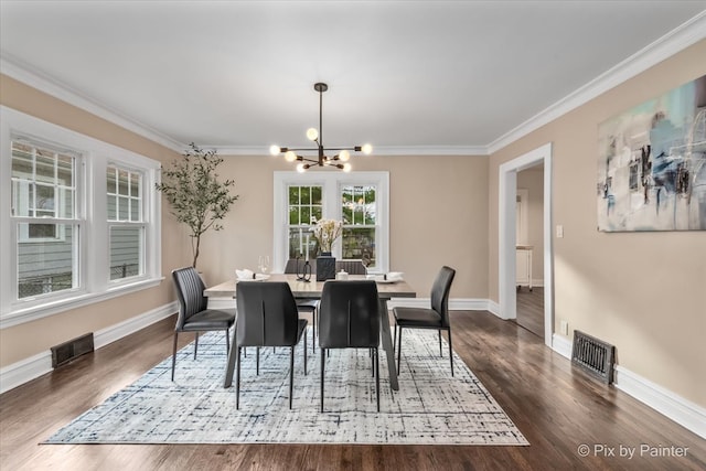 dining space featuring crown molding, dark hardwood / wood-style flooring, and a chandelier