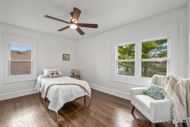 bedroom featuring multiple windows, ceiling fan, and dark hardwood / wood-style floors