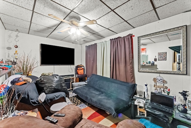 living room featuring a paneled ceiling and ceiling fan