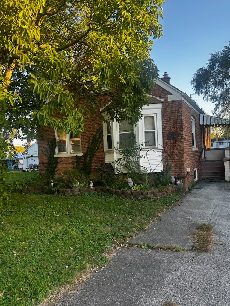 view of property exterior featuring a lawn