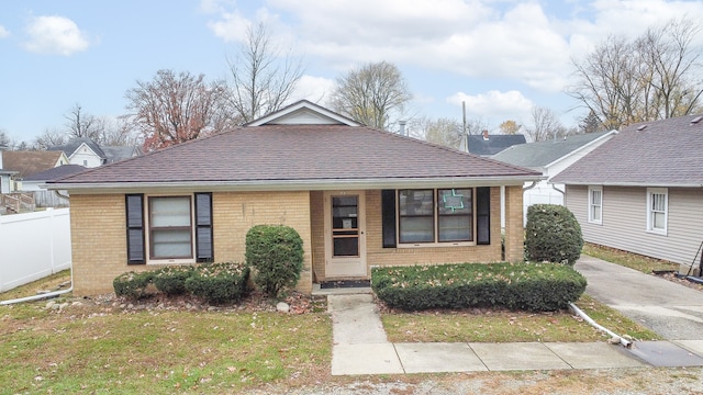 bungalow-style home featuring a front lawn