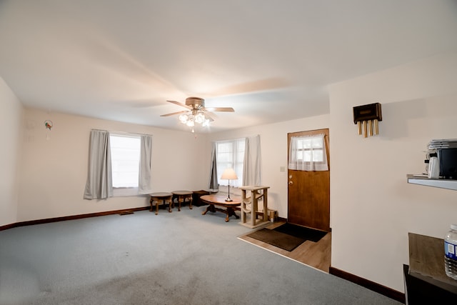 interior space featuring plenty of natural light, ceiling fan, and light colored carpet