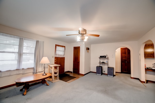 sitting room featuring light carpet and ceiling fan