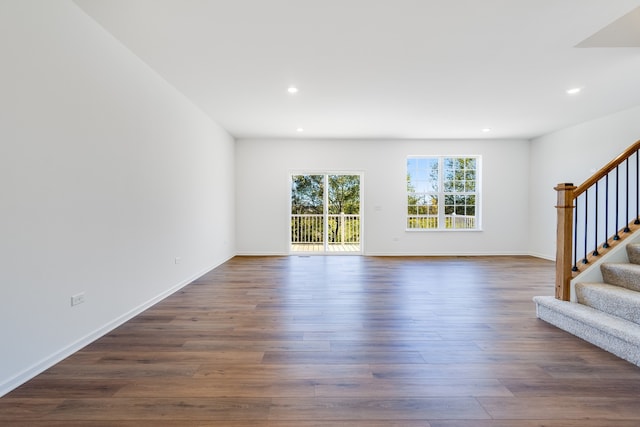 unfurnished living room featuring dark hardwood / wood-style flooring