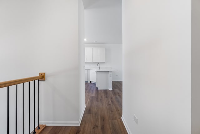 corridor with sink and dark hardwood / wood-style flooring