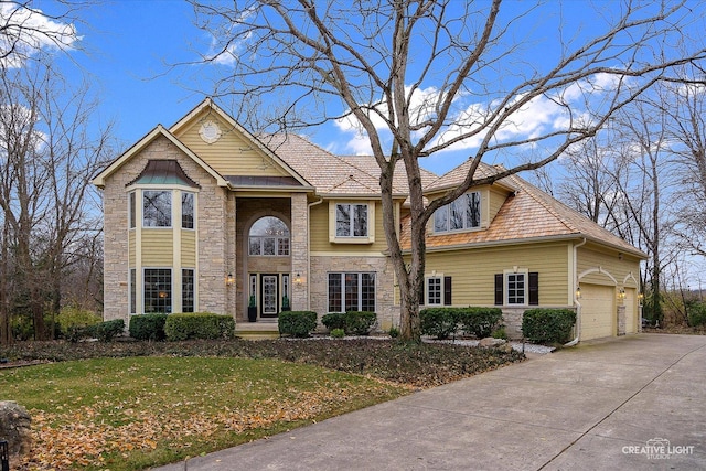 view of property with a front yard and a garage