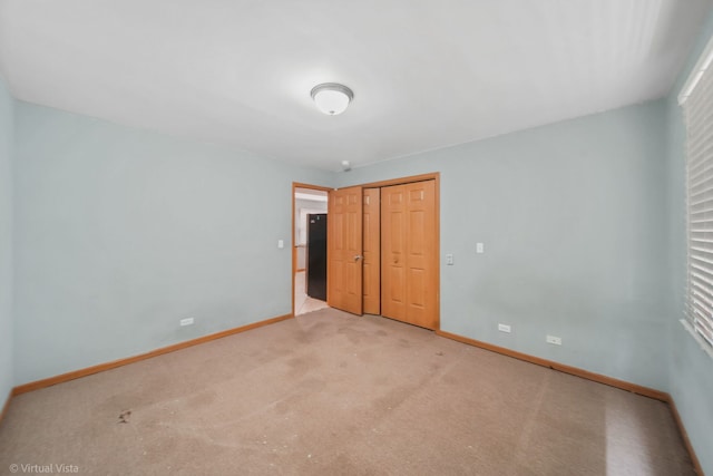 unfurnished bedroom featuring a closet and carpet floors