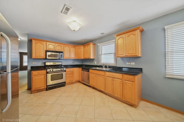 kitchen with light tile patterned floors, sink, and appliances with stainless steel finishes