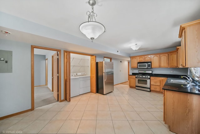 kitchen with sink, electric panel, washer / clothes dryer, pendant lighting, and appliances with stainless steel finishes