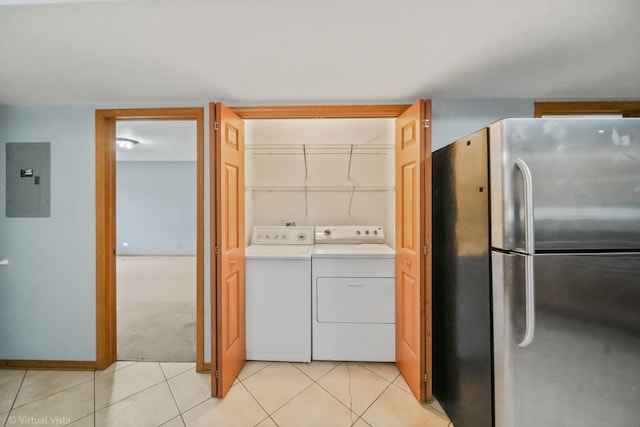 washroom with light tile patterned floors, independent washer and dryer, and electric panel