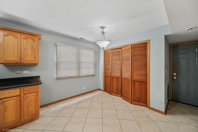 kitchen featuring pendant lighting and light tile patterned flooring