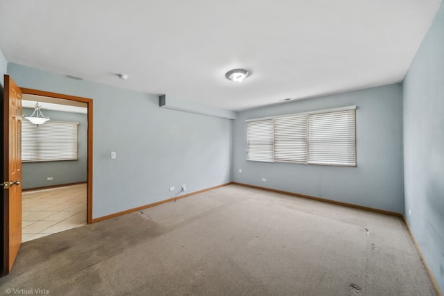 unfurnished room with light carpet