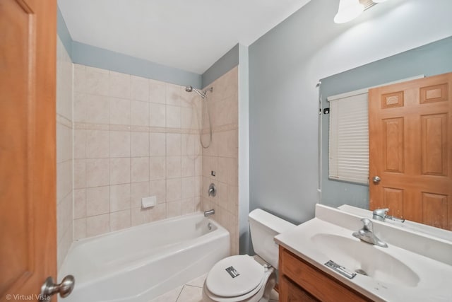 full bathroom featuring tile patterned floors, vanity, toilet, and tiled shower / bath combo