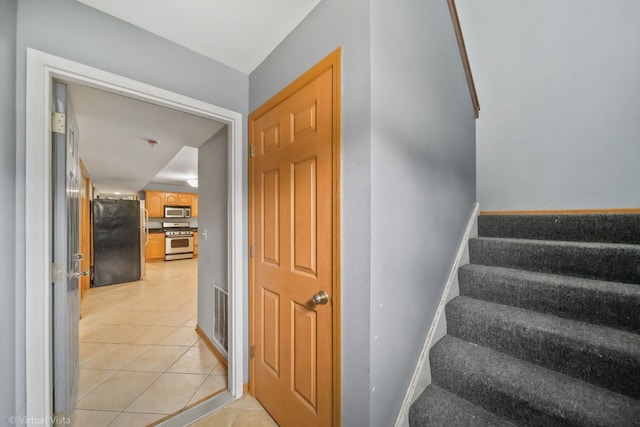 staircase featuring tile patterned flooring