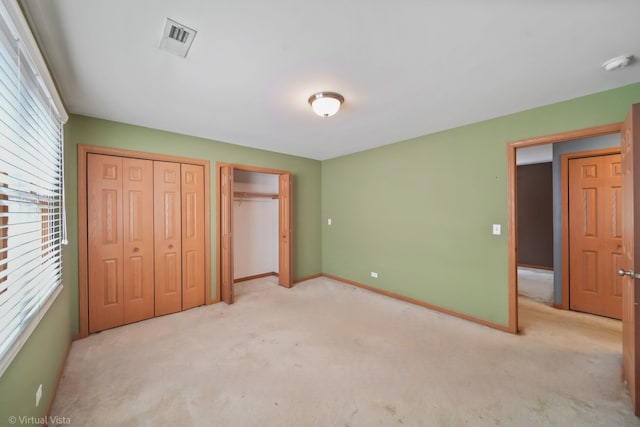 unfurnished bedroom with multiple windows and light carpet