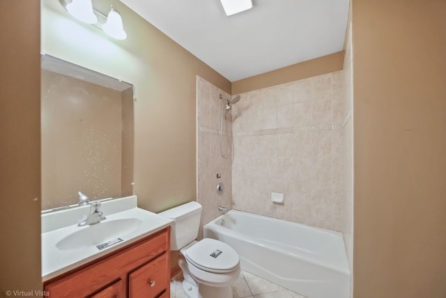 full bathroom featuring tile patterned flooring, vanity, toilet, and tiled shower / bath