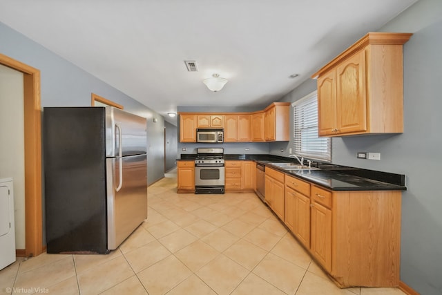 kitchen with sink, light tile patterned floors, and appliances with stainless steel finishes