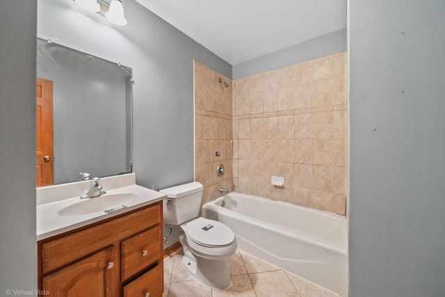 full bathroom featuring toilet, vanity, tile patterned floors, and tiled shower / bath